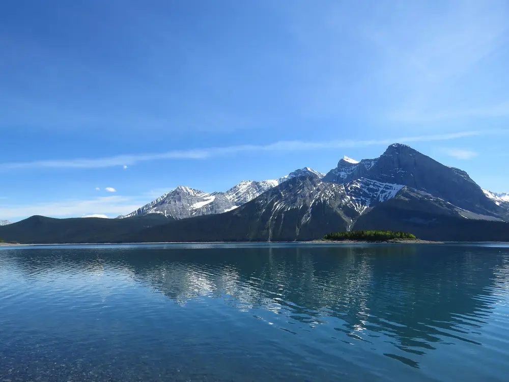 Upper Kananaskis Lake with forested shoreline and mountains